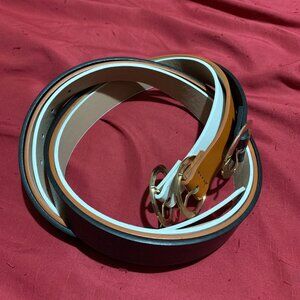 Black, brown, and white belts with gold buckles. 43 inches